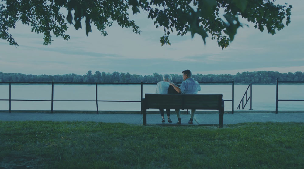 couple on bench looking at river